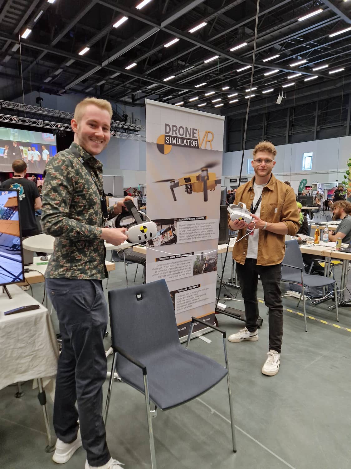 Drone Simulator VR developers demonstrating virtual drone training with VR headsets at an education and technology fair