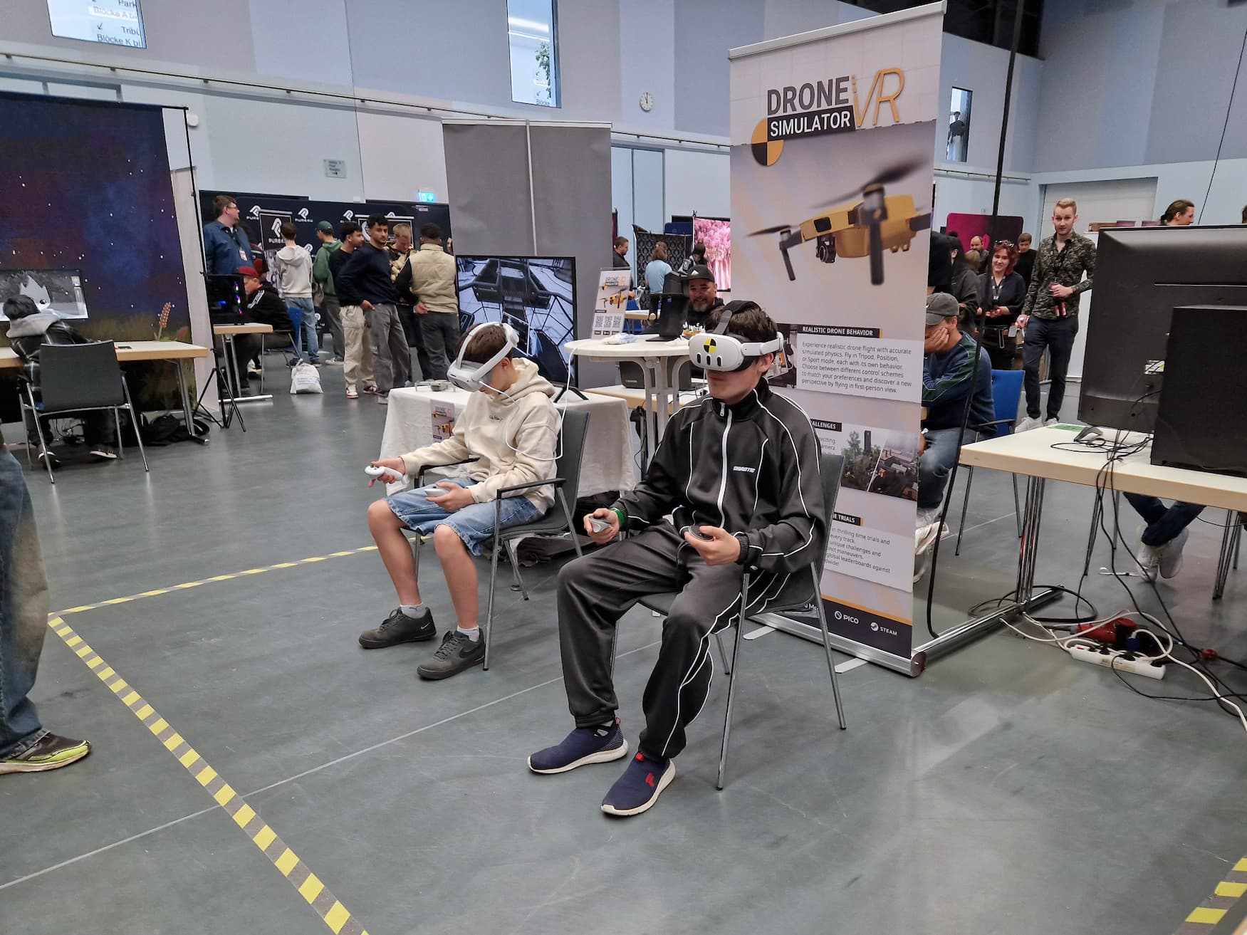 Young first-time users independently learning to fly virtual drones with Drone Simulator VR at an educational fair